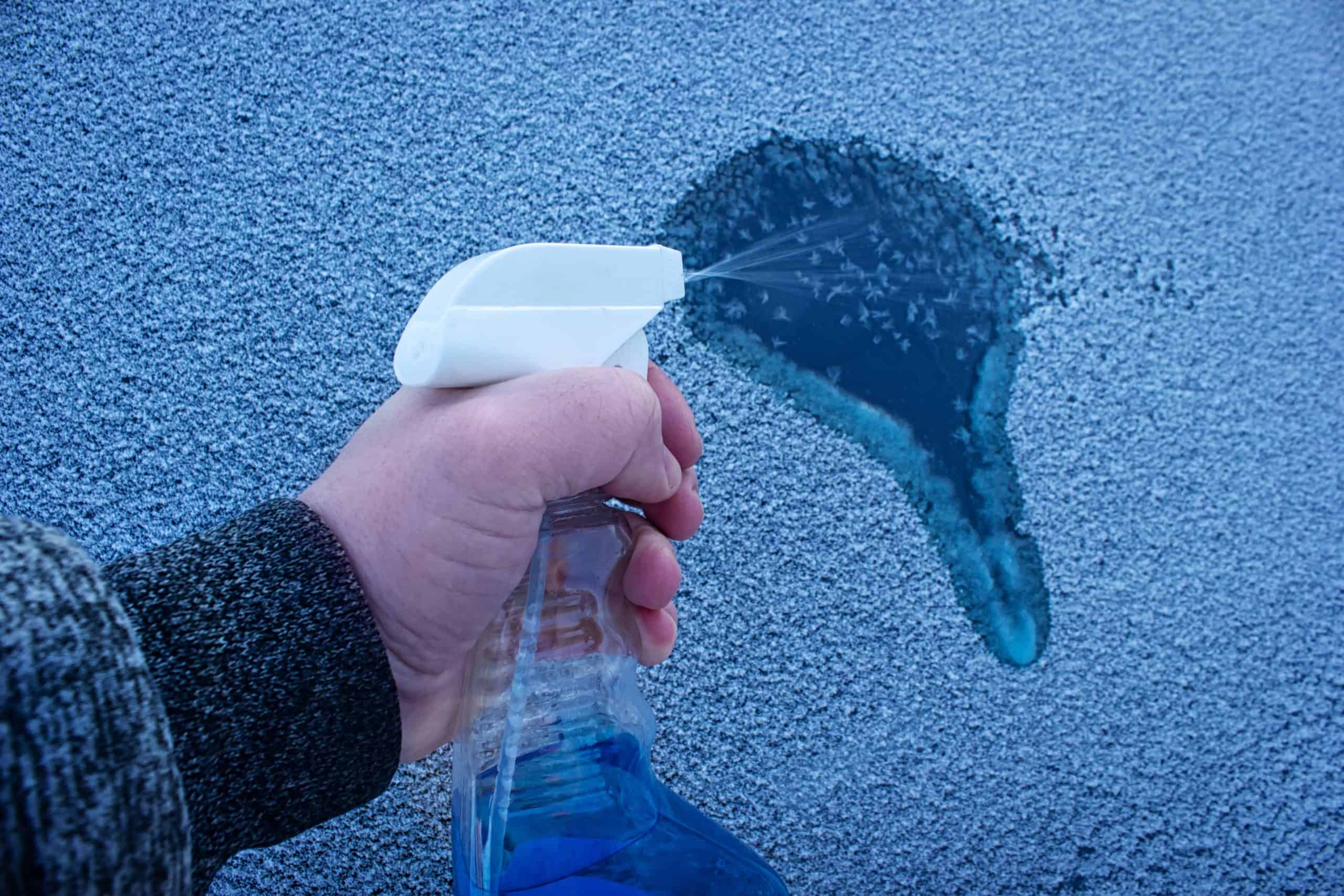 Spraying liquid de-icer to clear ice quickly