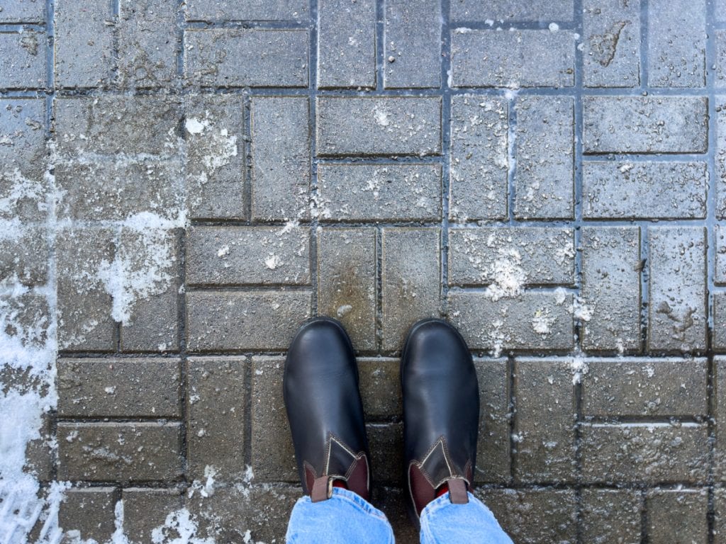 Commercial parking lot treated with liquid de-icer before a winter event