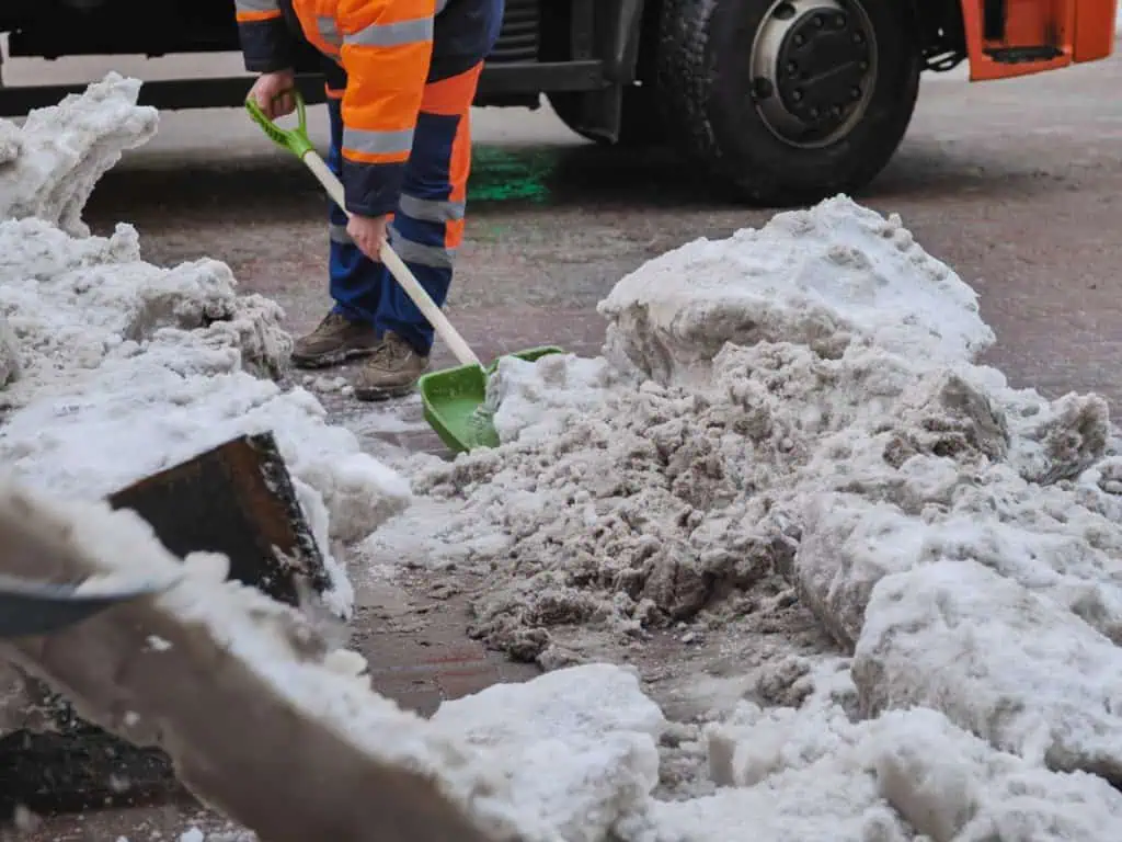 Crew maintaining a commercial property entrance in winter